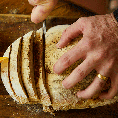 A loaf of bread being sliced